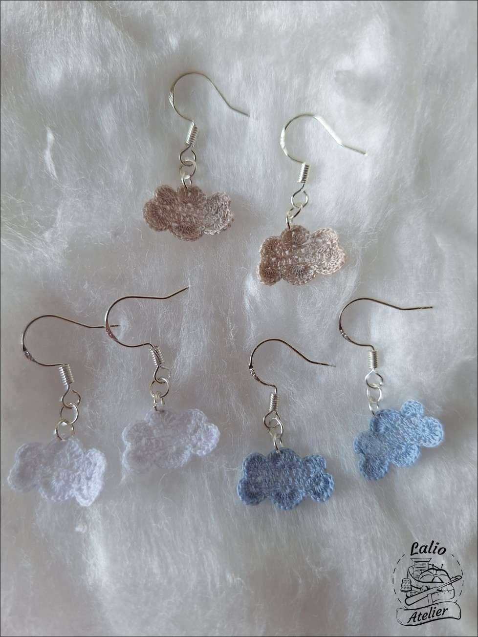 Drei Farbvarianten der gehäkelten Cloud Earrings – weiß, grau und hellblau – aus Baumwolle mit Sterlingsilber.