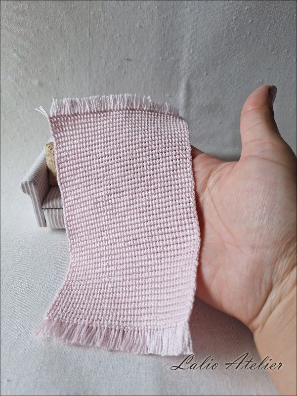 The photo shows the mini rug beautifully in relation to the hand