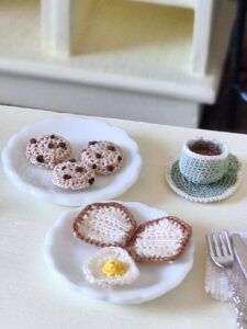 Micro crochet coffee mug displayed on a breakfast table in a 1:12 scale miniature kitchen