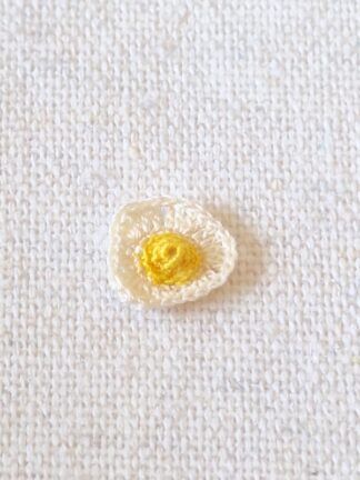 Handmade micro crochet fried egg for a 1:12 scale miniature breakfast scene