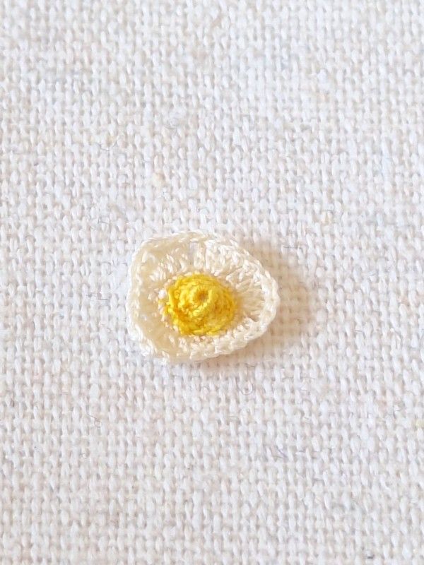 Handmade micro crochet fried egg for a 1:12 scale miniature breakfast scene