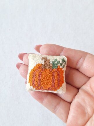 C2C Micro Crochet Pumpkin Cushion held in hand to show its tiny 1:12 scale