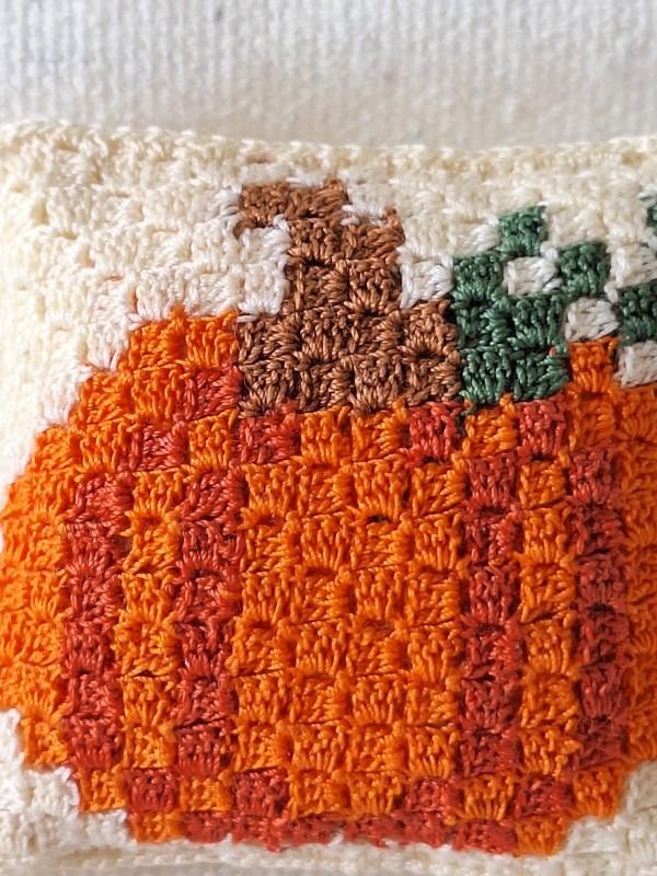 Close-up of the detailed C2C pumpkin motif crocheted with fine cotton thread